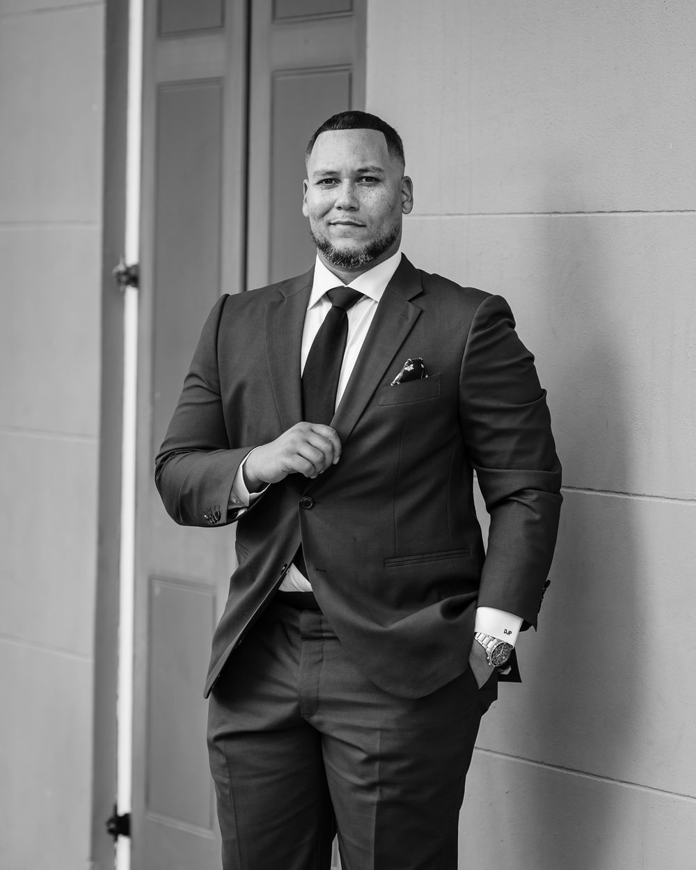 Attorney David Patin, Jr. of Litigator Law, LLC in a green suit with arms crossed